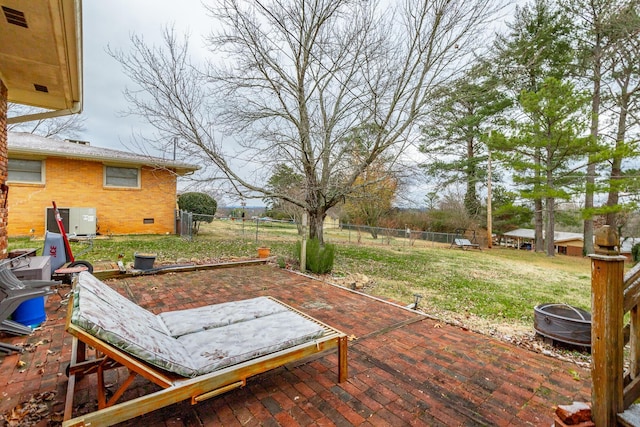 view of patio / terrace with central air condition unit and a fire pit