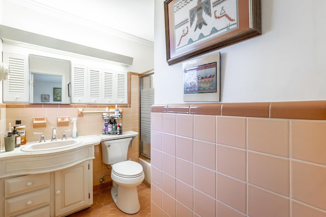 full bathroom with tile patterned floors, vanity, shower / bath combination with glass door, tile walls, and toilet