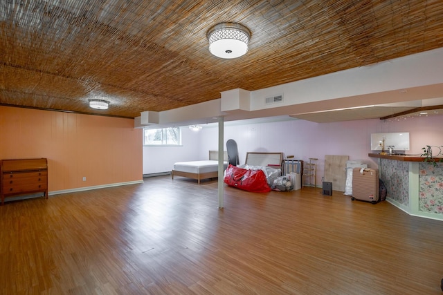 interior space with hardwood / wood-style flooring, wood ceiling, and a baseboard heating unit