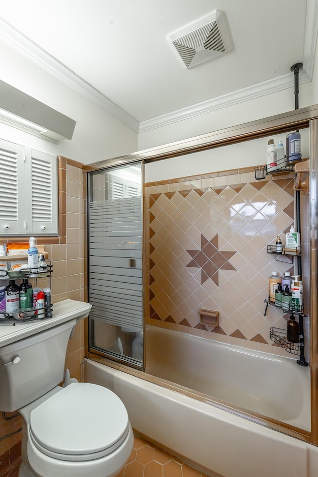 bathroom featuring tile patterned flooring, enclosed tub / shower combo, crown molding, toilet, and tile walls