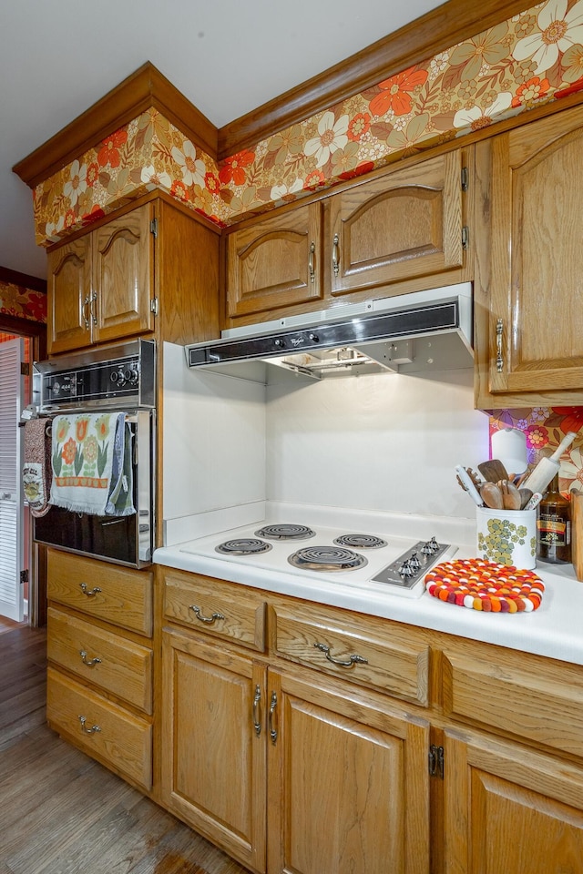 kitchen featuring light hardwood / wood-style flooring, black oven, and white cooktop