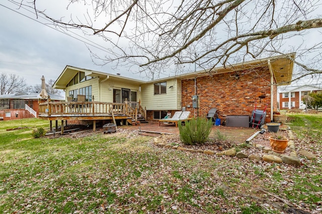 rear view of property with a lawn and a deck