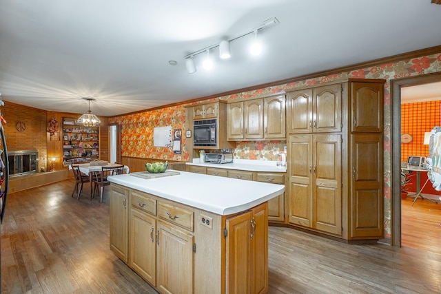 kitchen featuring a center island, light hardwood / wood-style floors, hanging light fixtures, and a notable chandelier