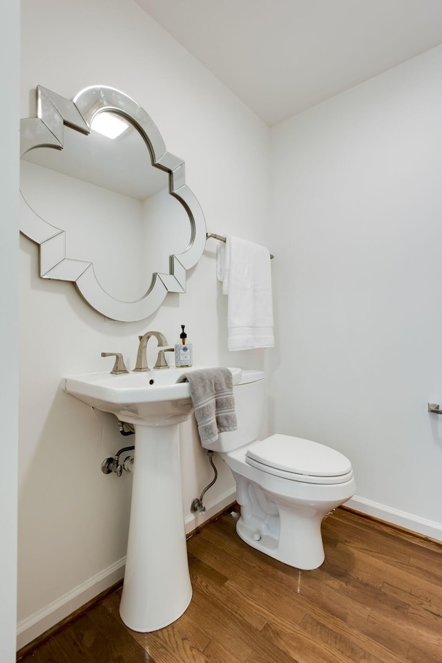 bathroom with wood-type flooring and toilet