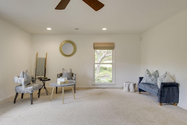 sitting room featuring ceiling fan and light carpet