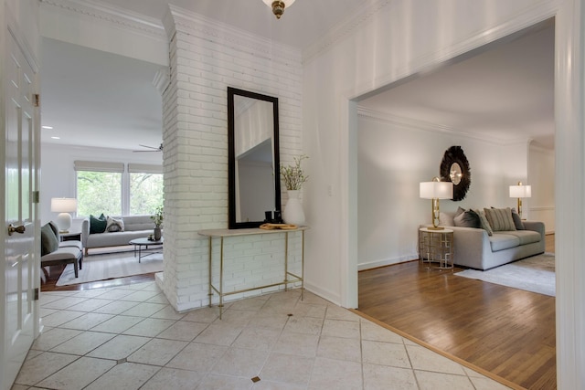 hall featuring light tile patterned floors and ornamental molding