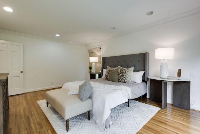 bedroom featuring ornamental molding and hardwood / wood-style flooring