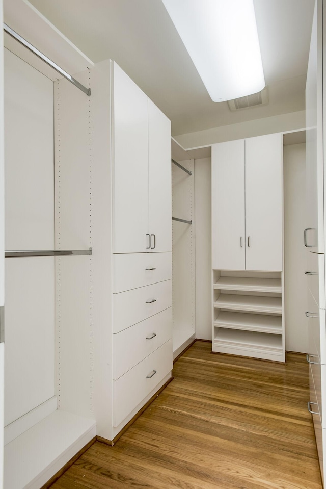 spacious closet with light hardwood / wood-style floors