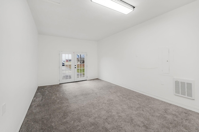 carpeted empty room featuring french doors and electric panel