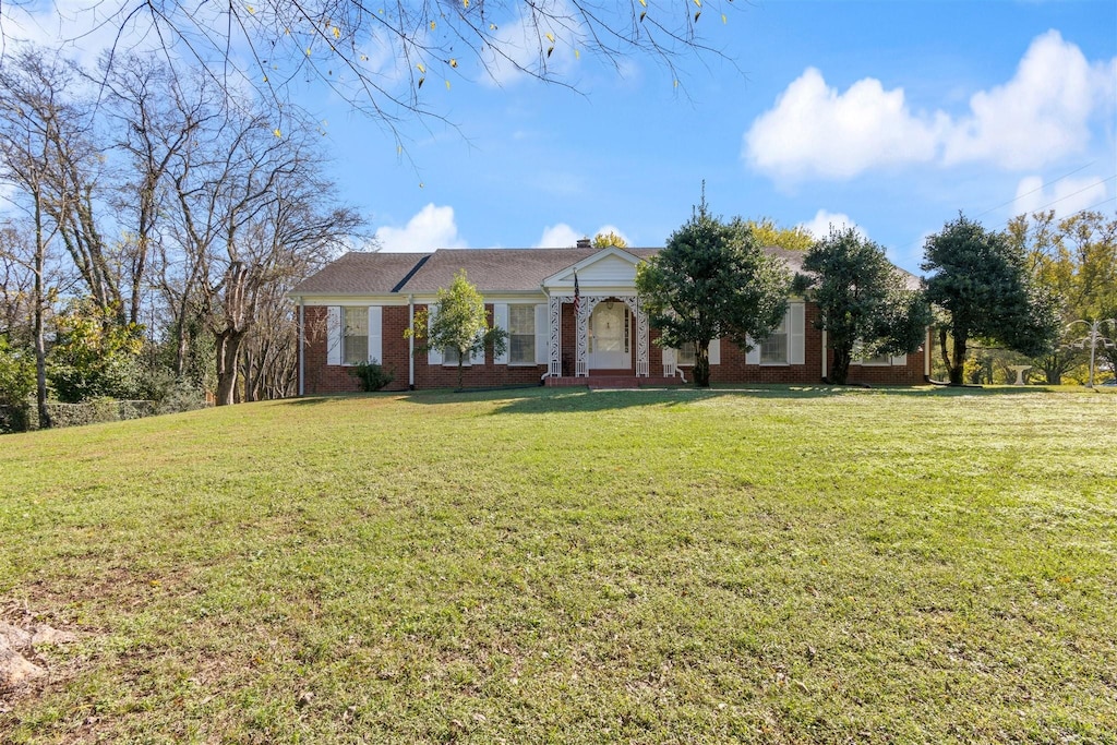 ranch-style home featuring a front yard