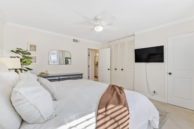 bedroom featuring ceiling fan, light colored carpet, crown molding, and a closet