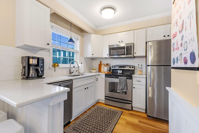 kitchen with sink, white cabinets, and appliances with stainless steel finishes