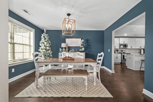 dining space with a chandelier and dark wood-type flooring