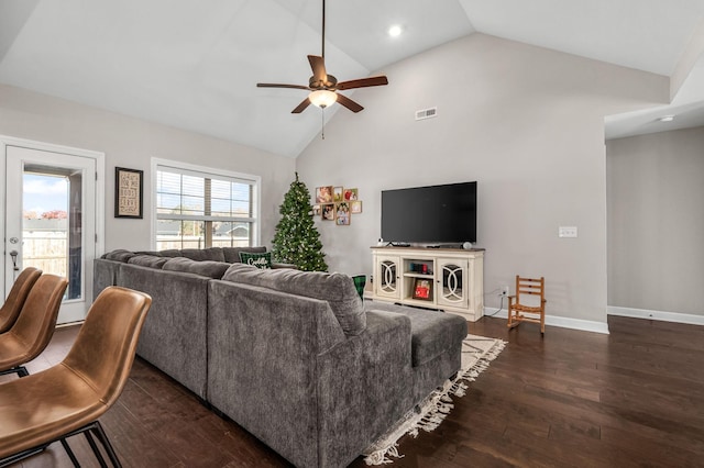 living room featuring dark hardwood / wood-style flooring, high vaulted ceiling, and ceiling fan