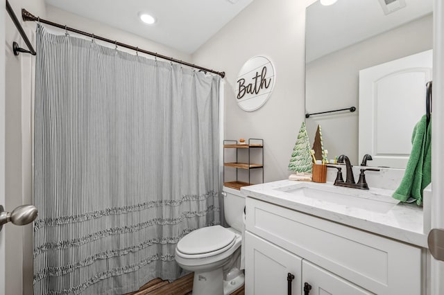 bathroom with walk in shower, vanity, wood-type flooring, and toilet