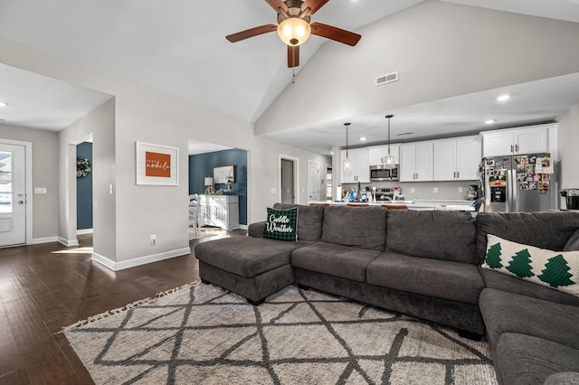 living room featuring ceiling fan, dark hardwood / wood-style flooring, and high vaulted ceiling