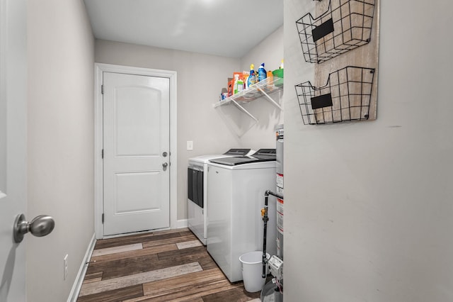 laundry area with dark hardwood / wood-style floors and washer and clothes dryer