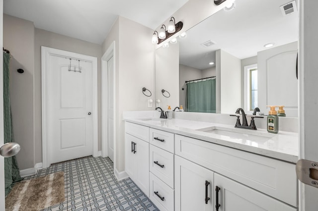 bathroom with tile patterned flooring and vanity