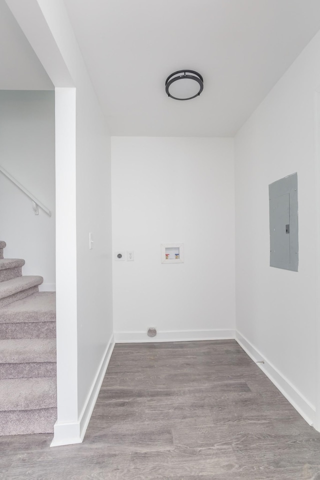 washroom featuring washer hookup, electric panel, hardwood / wood-style flooring, and electric dryer hookup