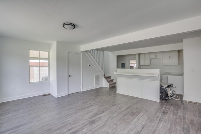 unfurnished living room with dark hardwood / wood-style flooring