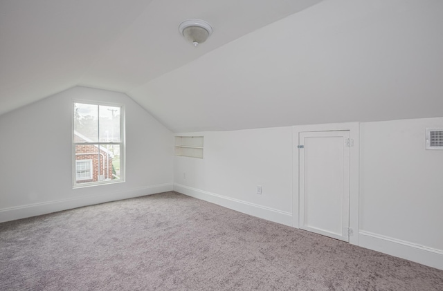 bonus room with carpet floors and lofted ceiling