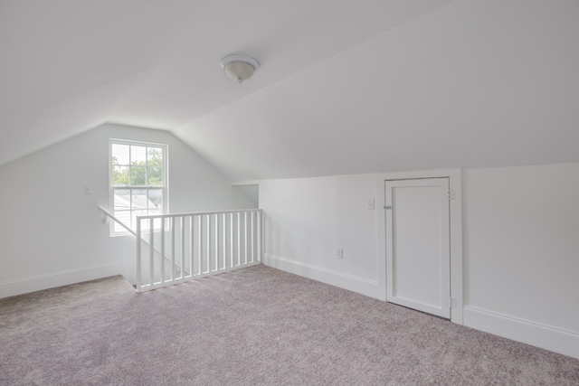 bonus room featuring light colored carpet and lofted ceiling