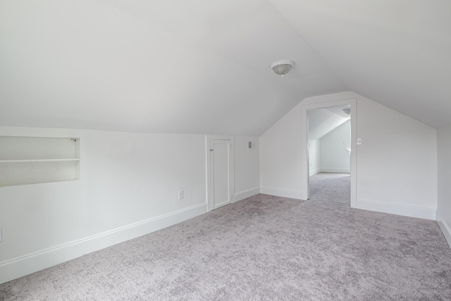 bonus room featuring lofted ceiling and carpet floors