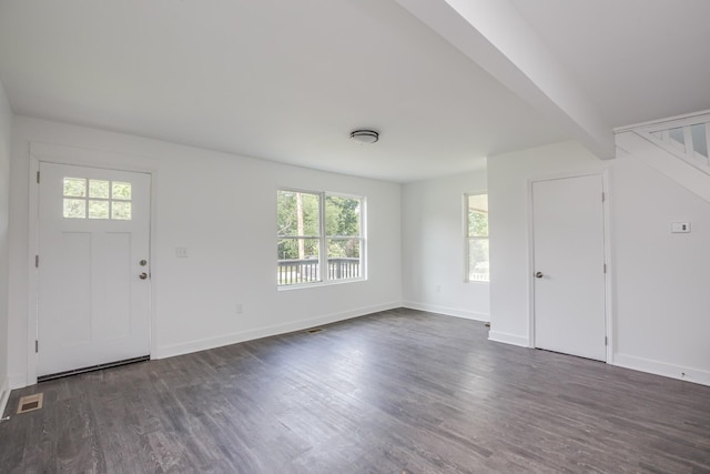 entryway with beam ceiling and dark hardwood / wood-style flooring