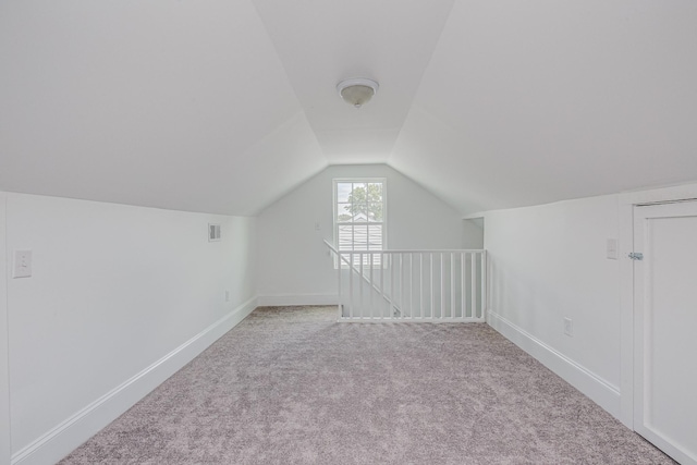 bonus room featuring light colored carpet and lofted ceiling