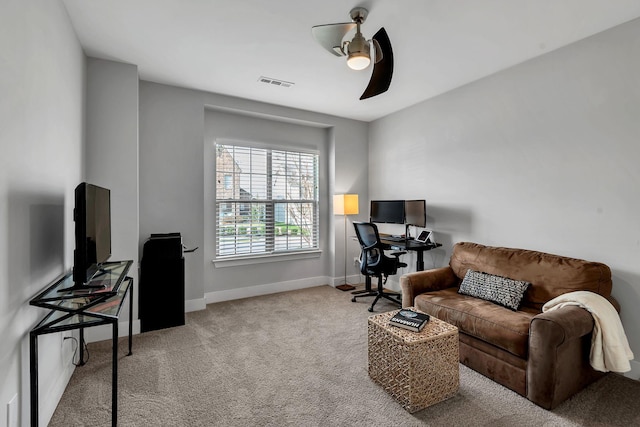 interior space with ceiling fan and light colored carpet