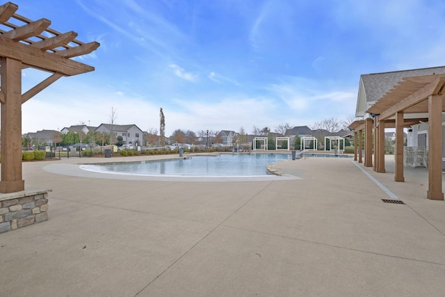 view of swimming pool with a pergola and a patio