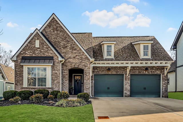 view of front of house featuring a front yard and a garage