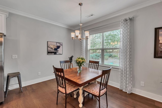 dining room featuring dark wood-type flooring, a wealth of natural light, crown molding, and a chandelier