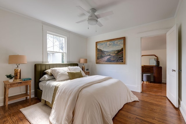 bedroom featuring ceiling fan, dark hardwood / wood-style flooring, and crown molding