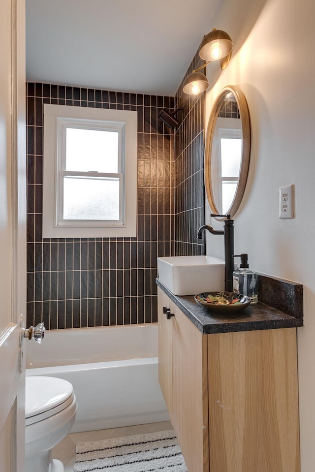 full bathroom with tile patterned floors, vanity, toilet, and tiled shower / bath