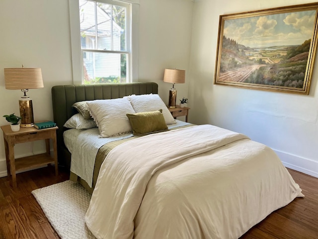 bedroom with dark hardwood / wood-style flooring