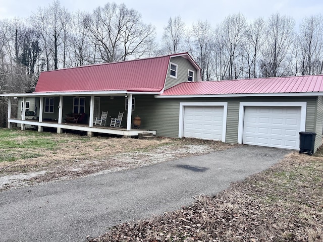 view of front of house featuring covered porch and a garage