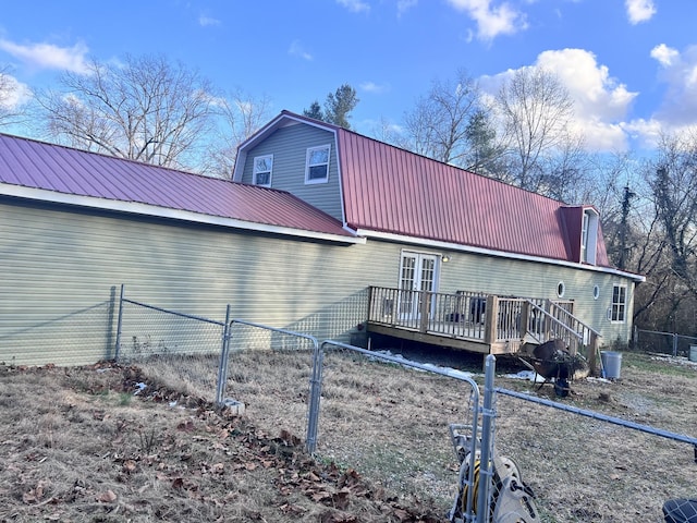 back of house featuring a wooden deck