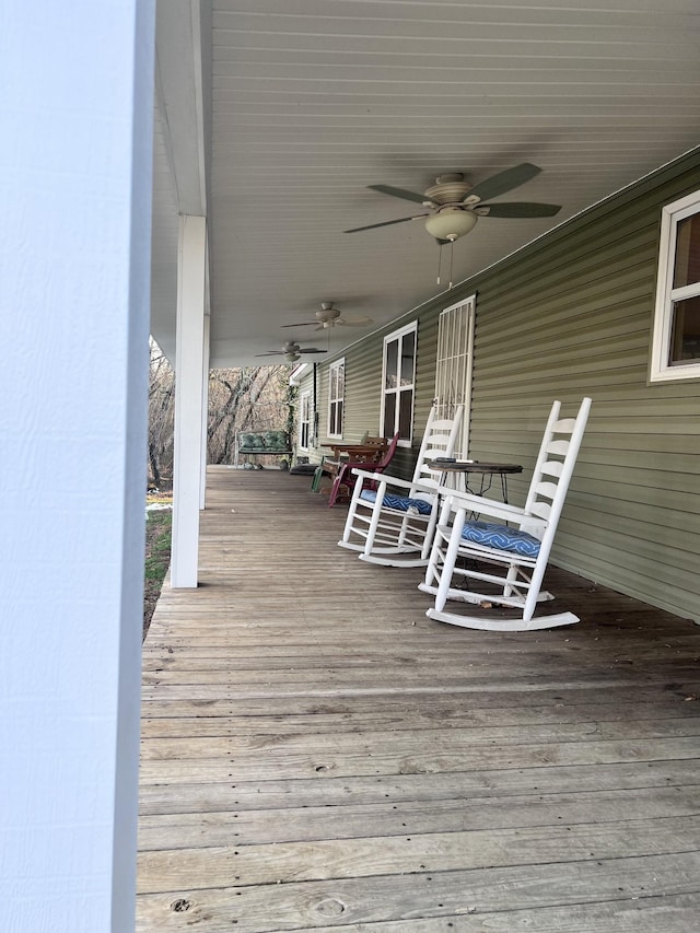 deck with a porch and ceiling fan