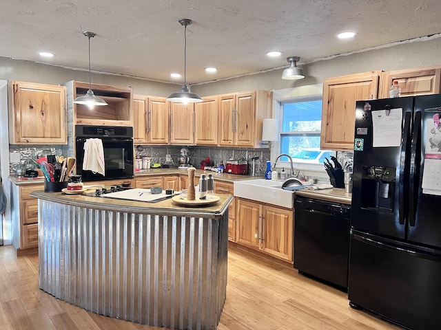 kitchen featuring light brown cabinets, sink, hanging light fixtures, tasteful backsplash, and black appliances