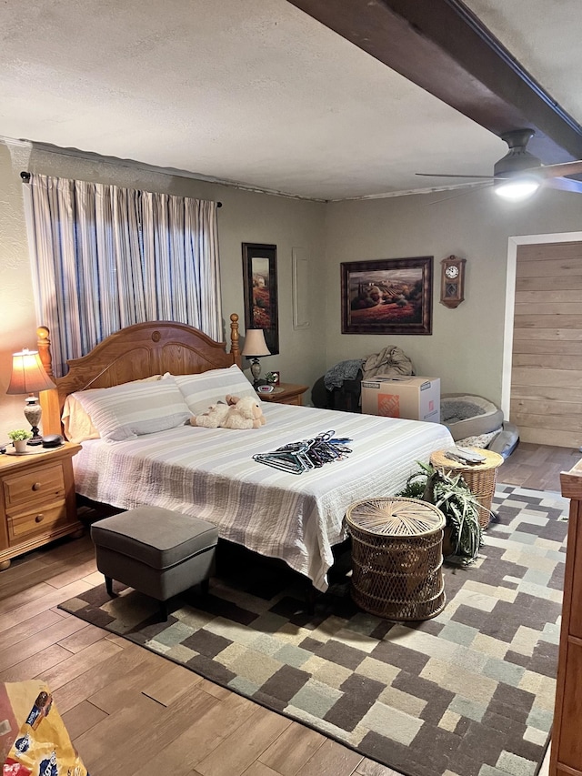 bedroom featuring ceiling fan, a textured ceiling, and light wood-type flooring