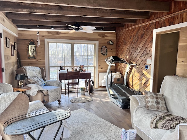 living room featuring beam ceiling, wooden walls, and hardwood / wood-style flooring