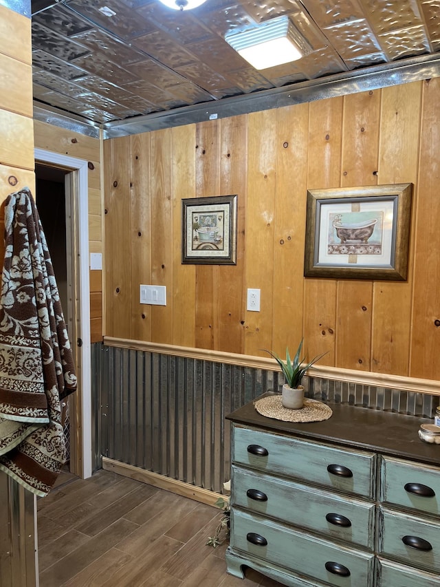 bathroom with wood-type flooring and wood walls