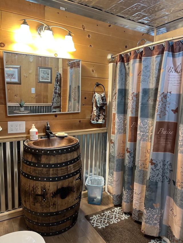 bathroom featuring wood walls and wood-type flooring