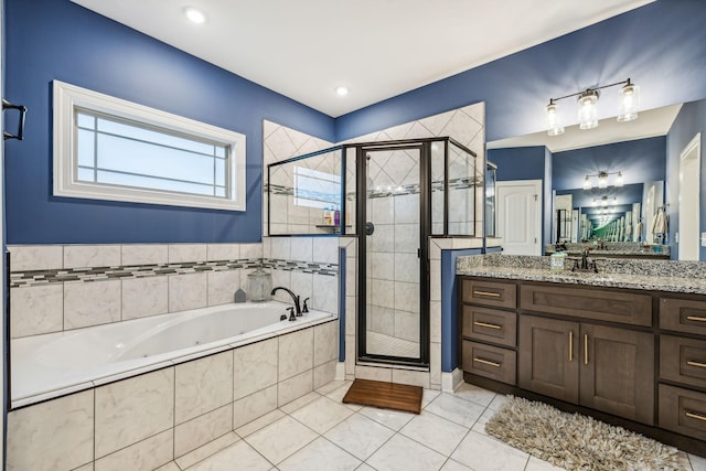 bathroom featuring tile patterned floors, vanity, and independent shower and bath