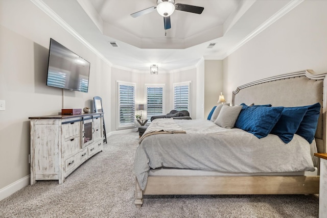 carpeted bedroom featuring ceiling fan, crown molding, and a tray ceiling