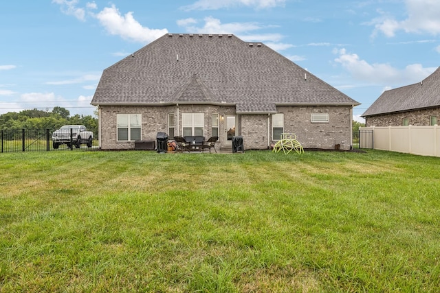 back of property featuring a patio and a lawn