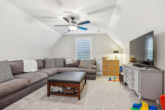 carpeted living room with ceiling fan and vaulted ceiling