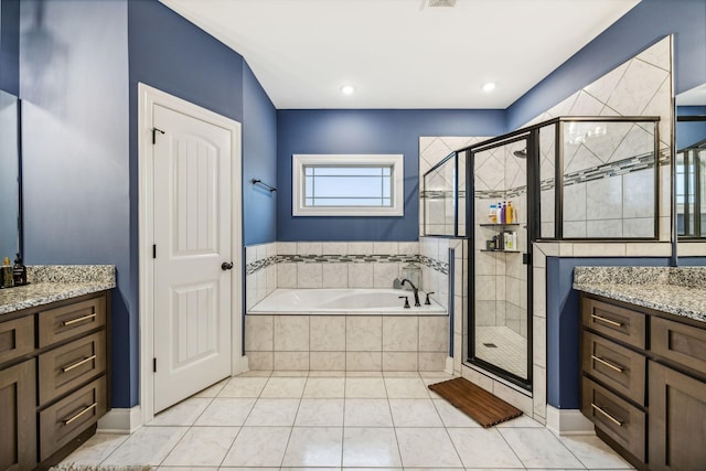 bathroom with tile patterned flooring, vanity, and separate shower and tub