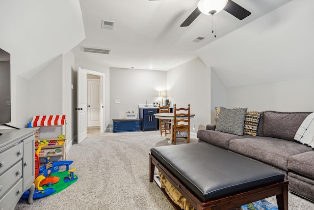 living room with ceiling fan, light colored carpet, and lofted ceiling